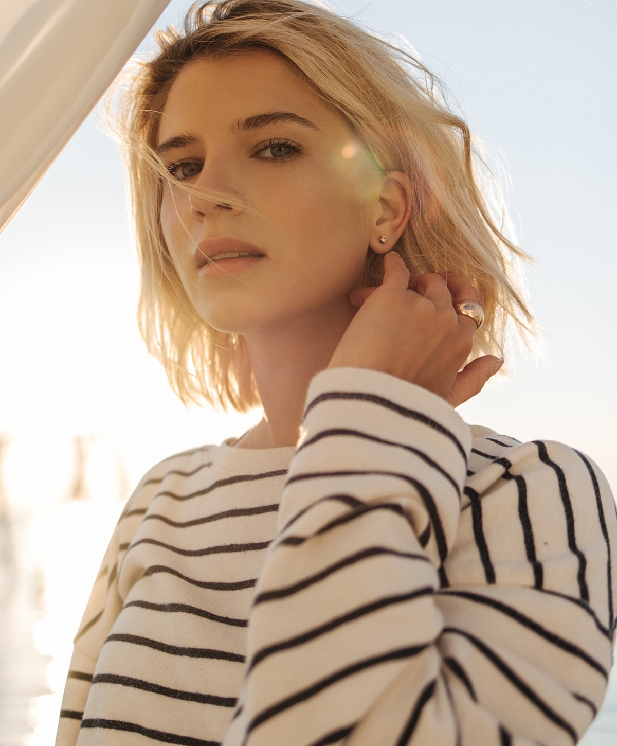 Woman with short hair in striped sweater.