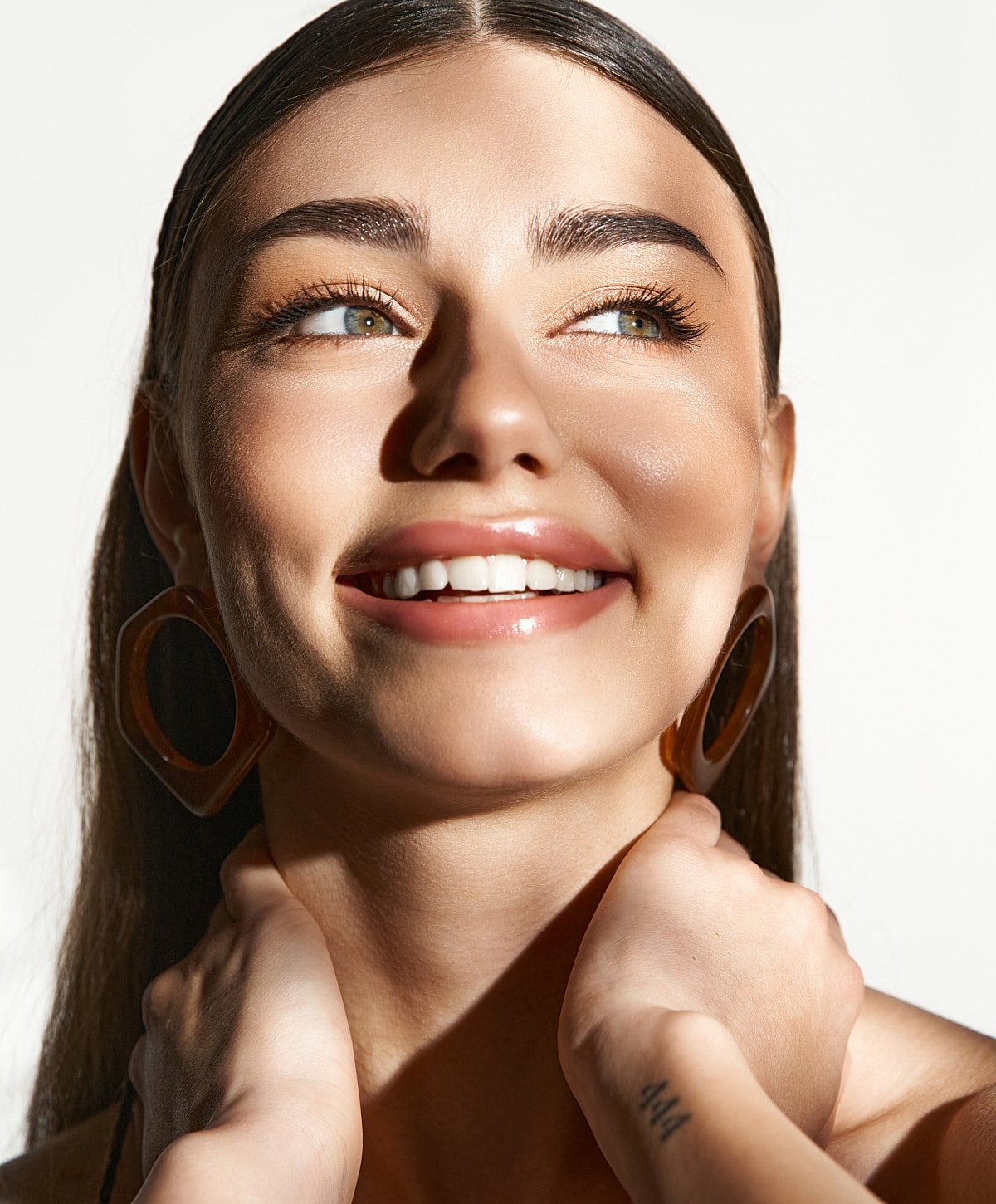 Smiling woman with earrings and natural beauty.