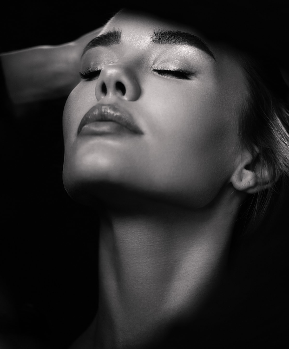 Black and white close-up of a serene face.