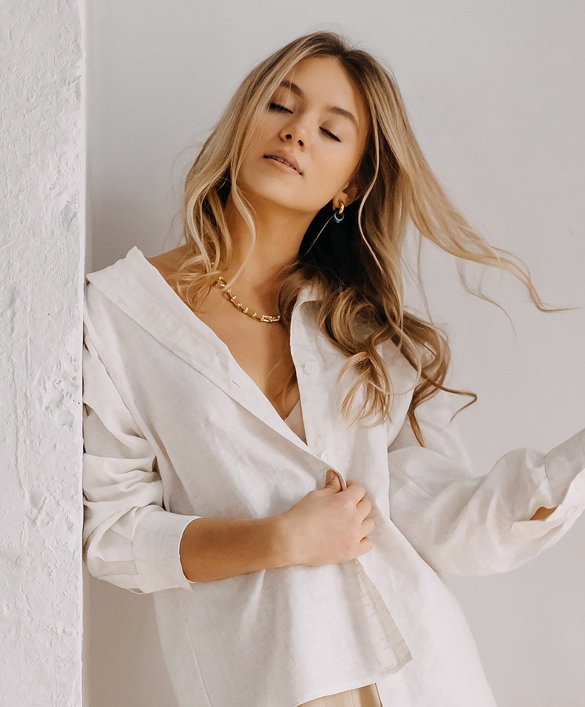 Woman in white shirt with flowing hair.