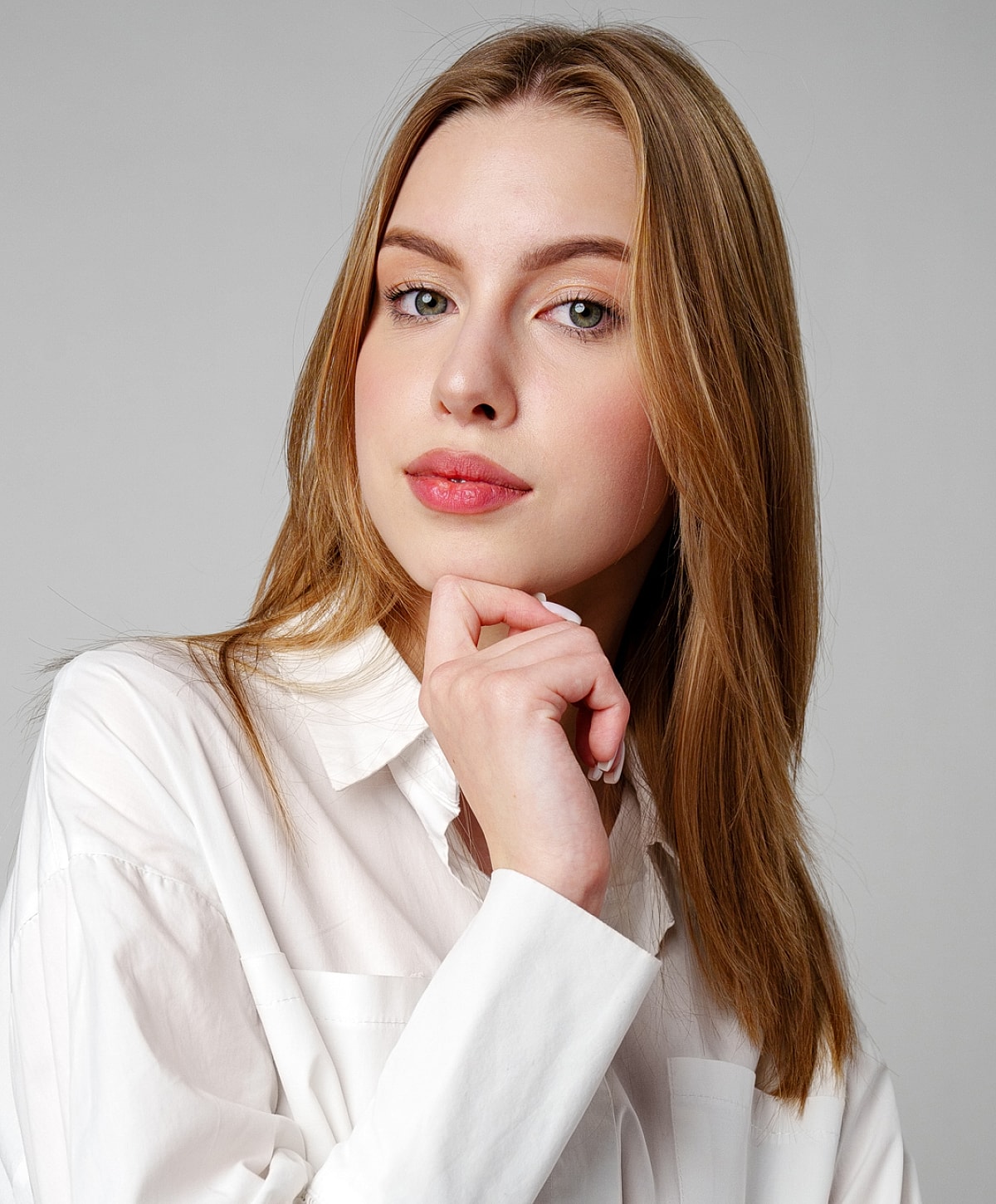 Profile view of a model with sleek hair.