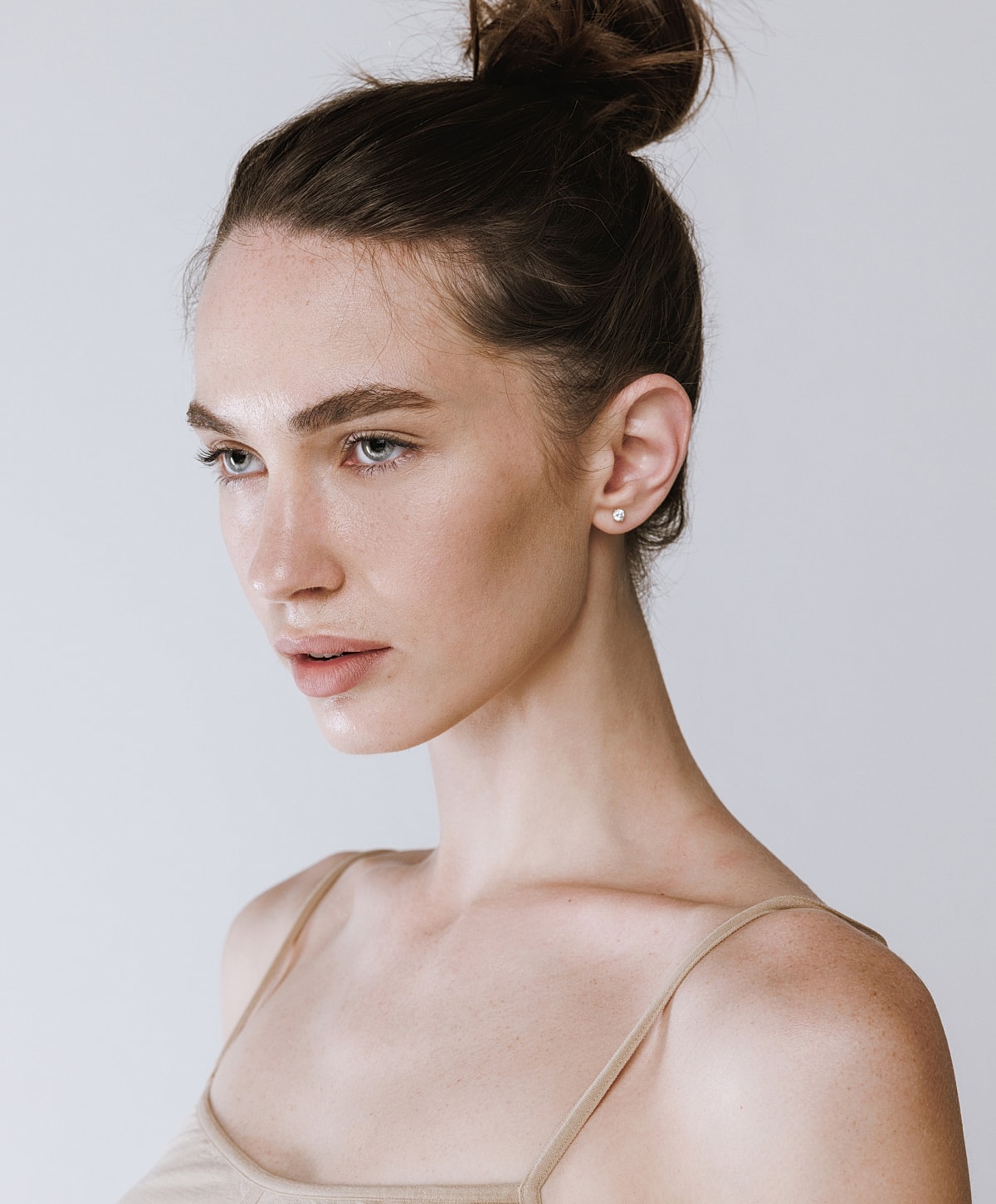 Model with natural makeup against a light background.