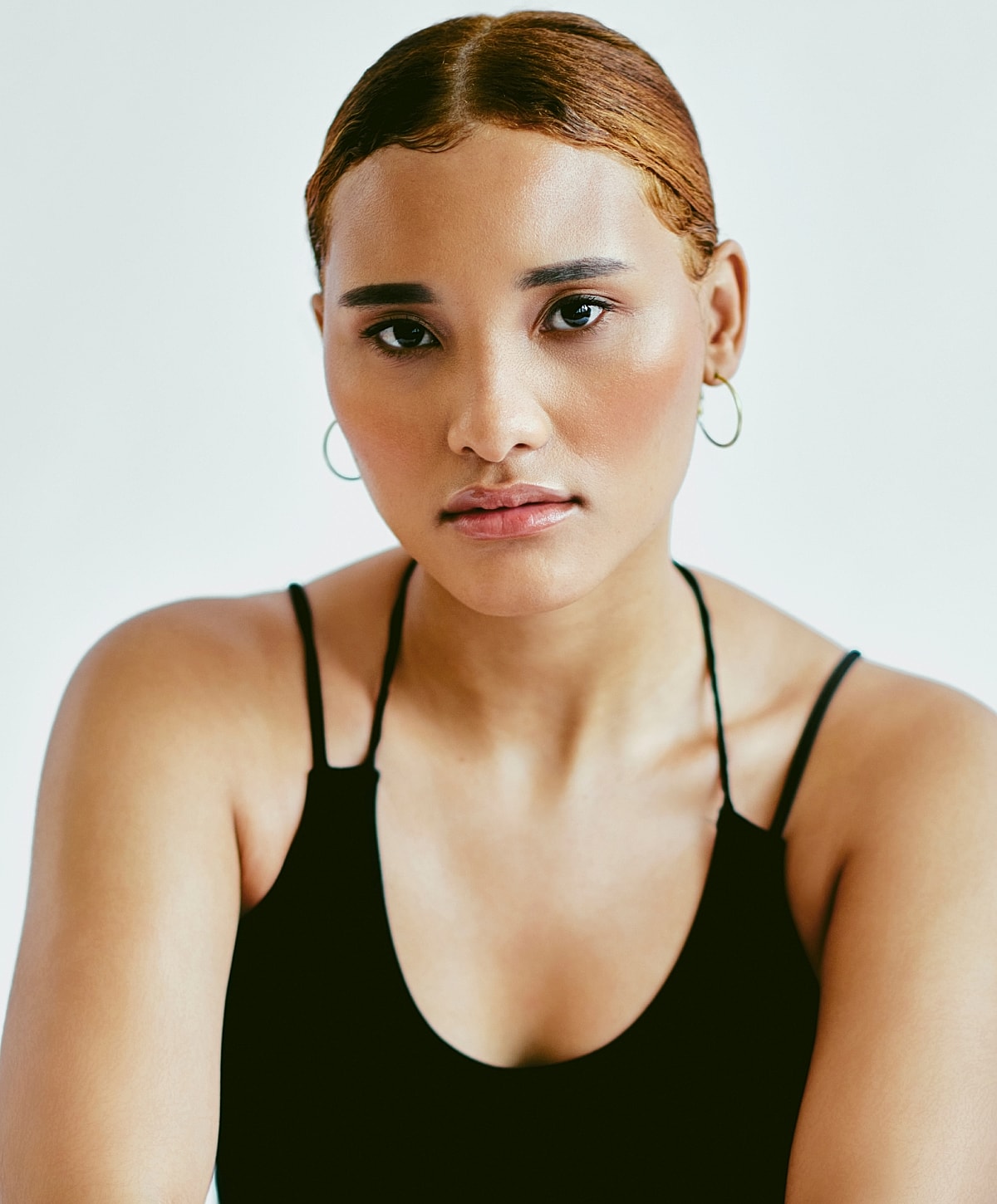 Portrait of a woman with sleek hairstyle.