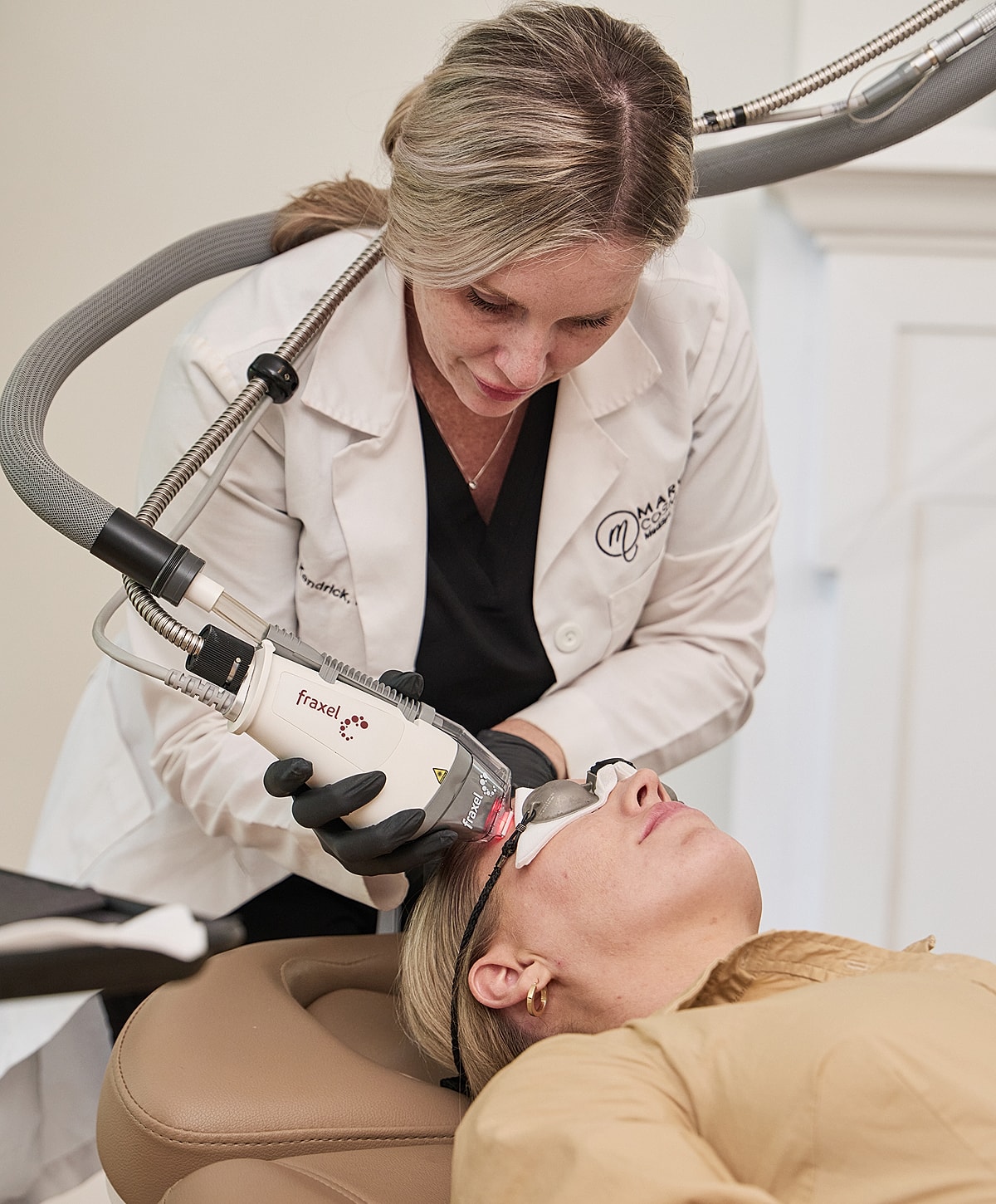 Client receiving facial treatment at beauty clinic.