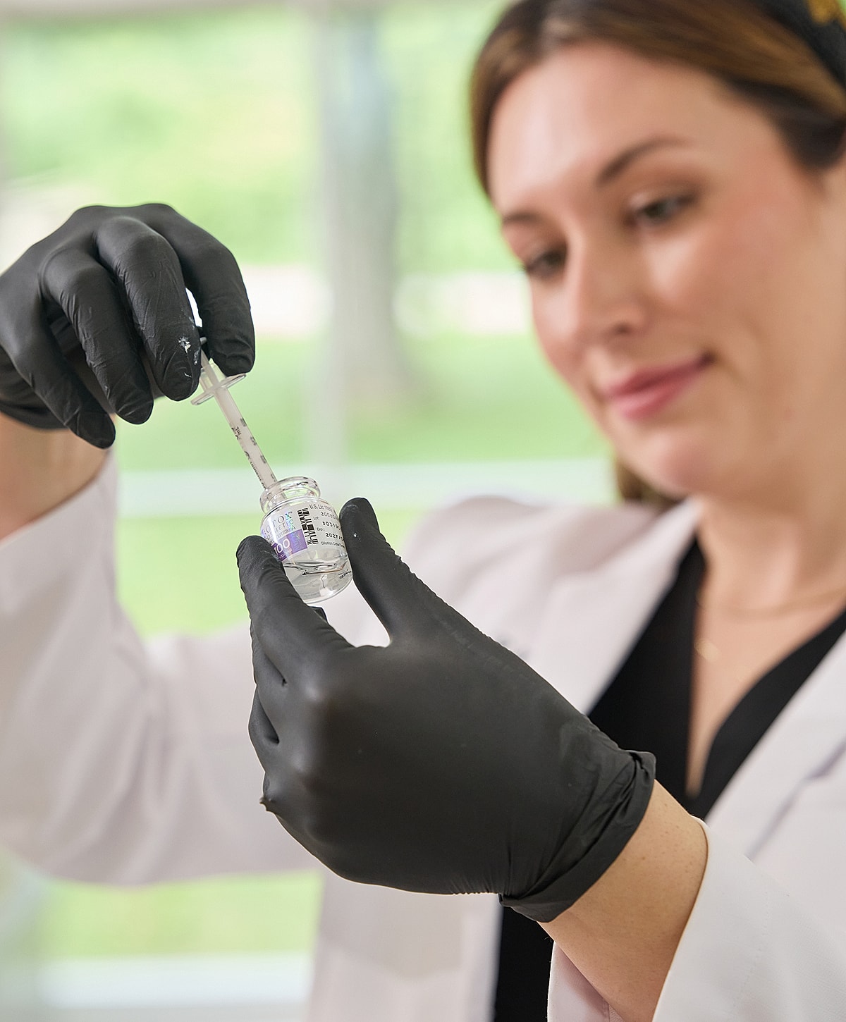 Client receiving facial treatment at beauty clinic.