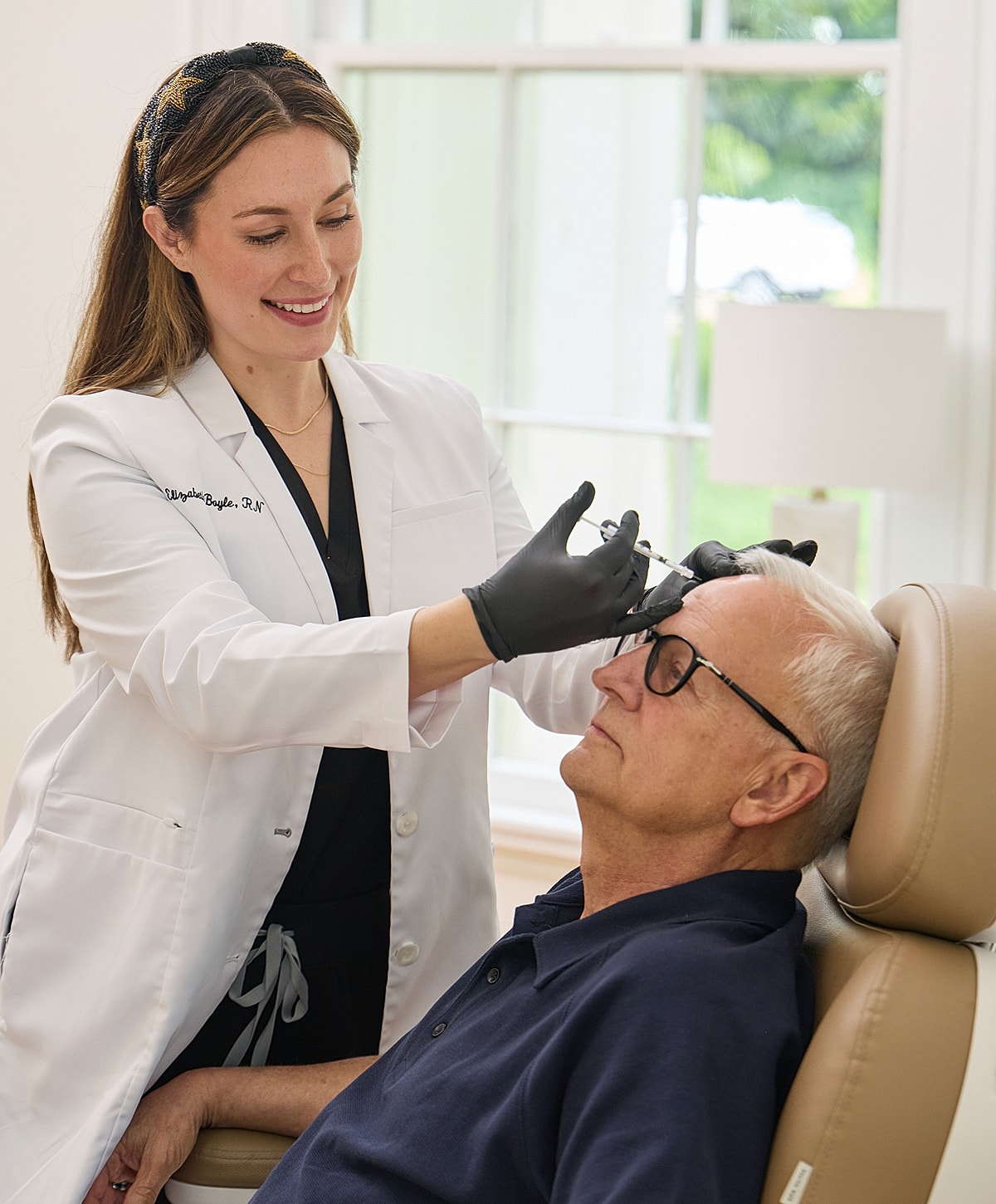 Client receiving facial treatment at beauty clinic.