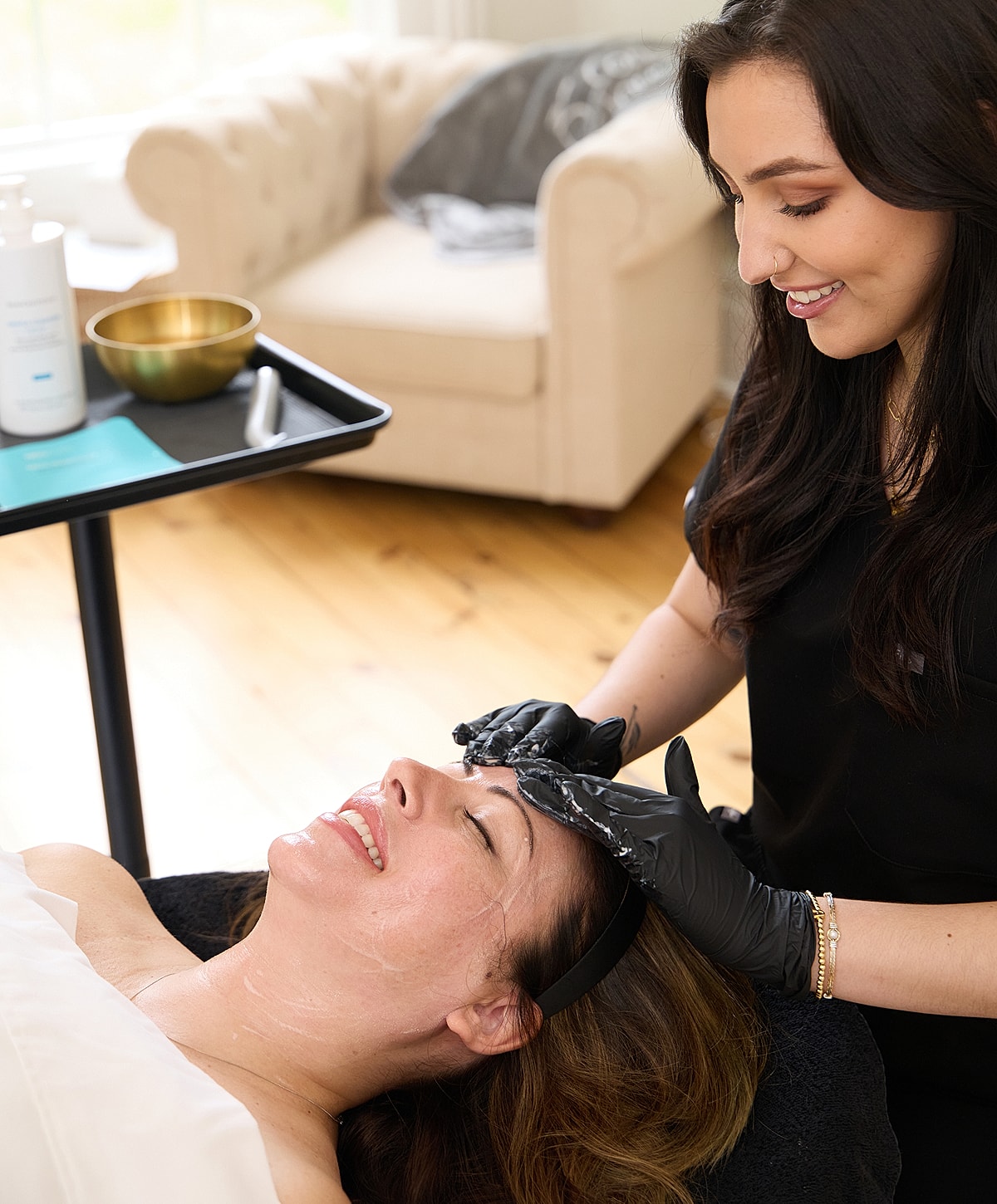Client receiving facial treatment at beauty clinic.