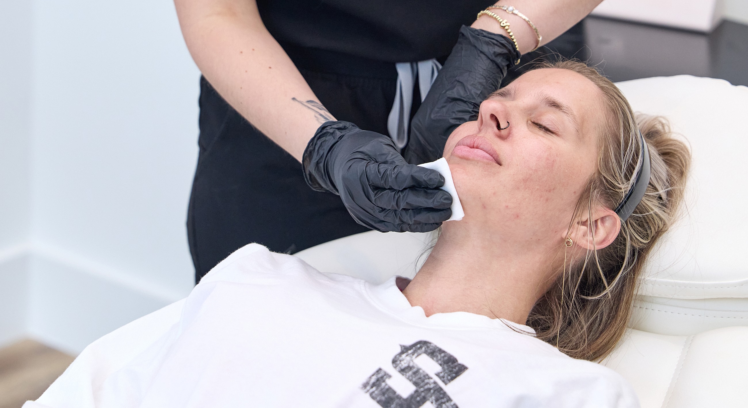 Facial treatment in progress at a skincare clinic.