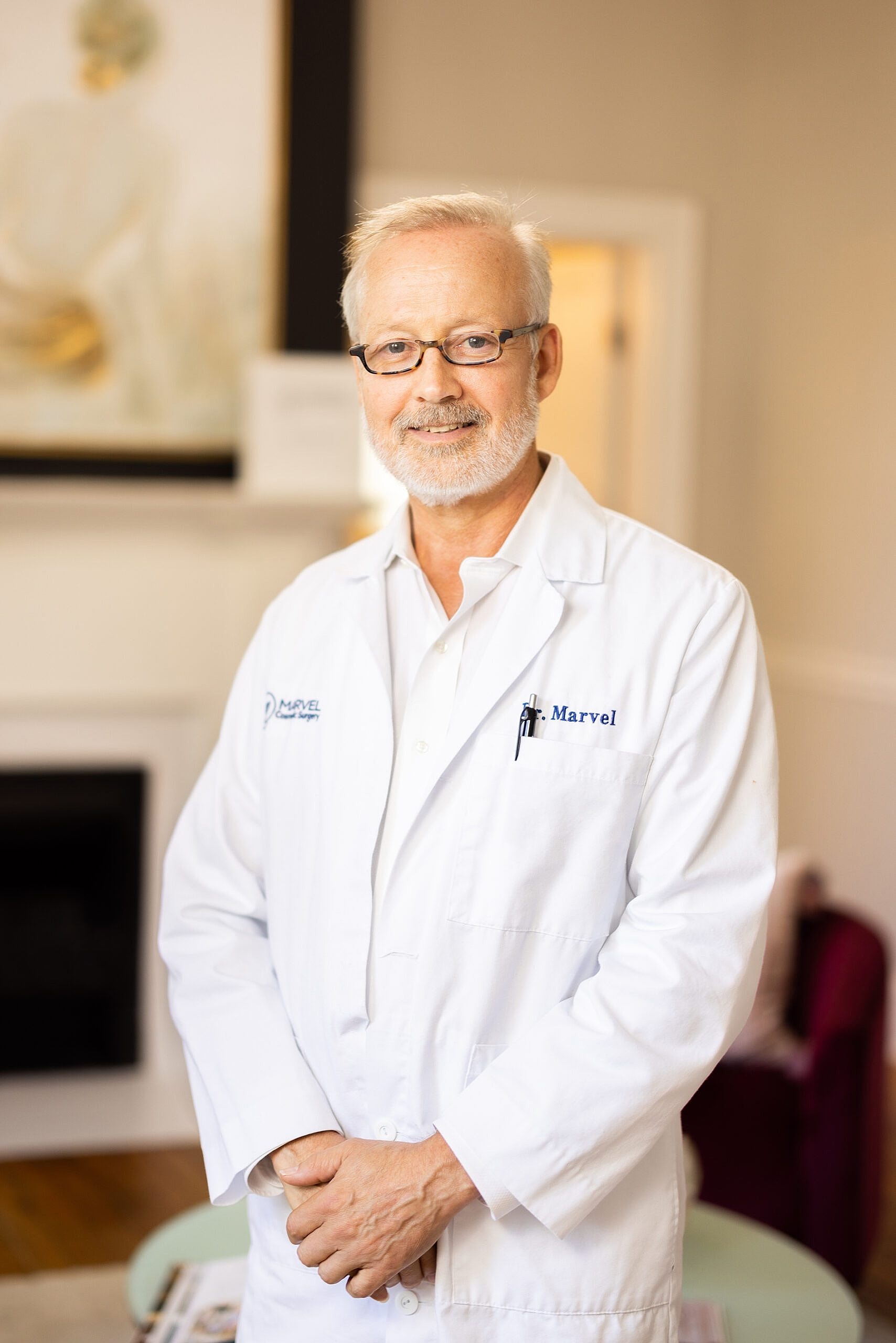 Doctor in white coat smiling confidently indoors.