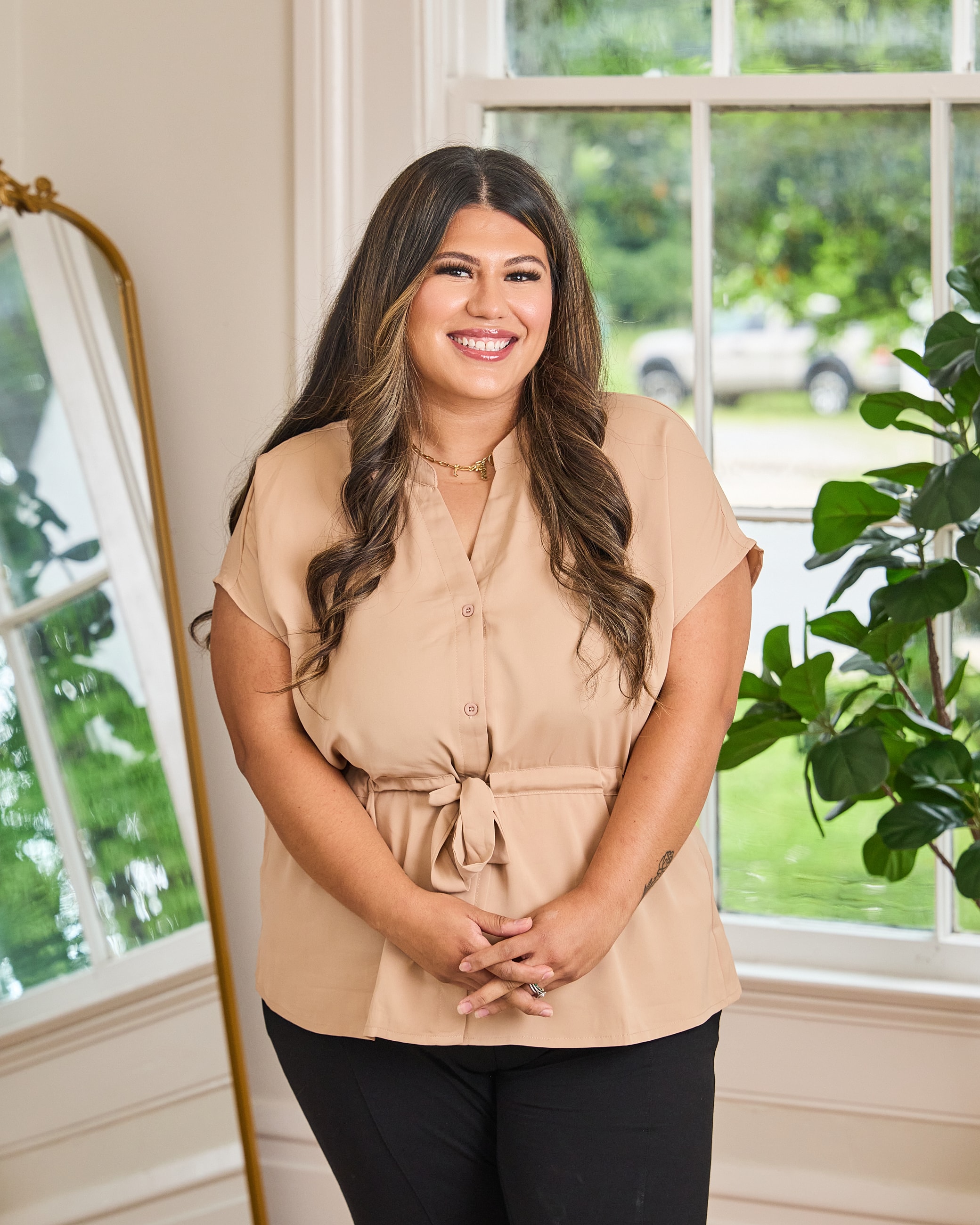 Smiling woman in a stylish dress indoors.
