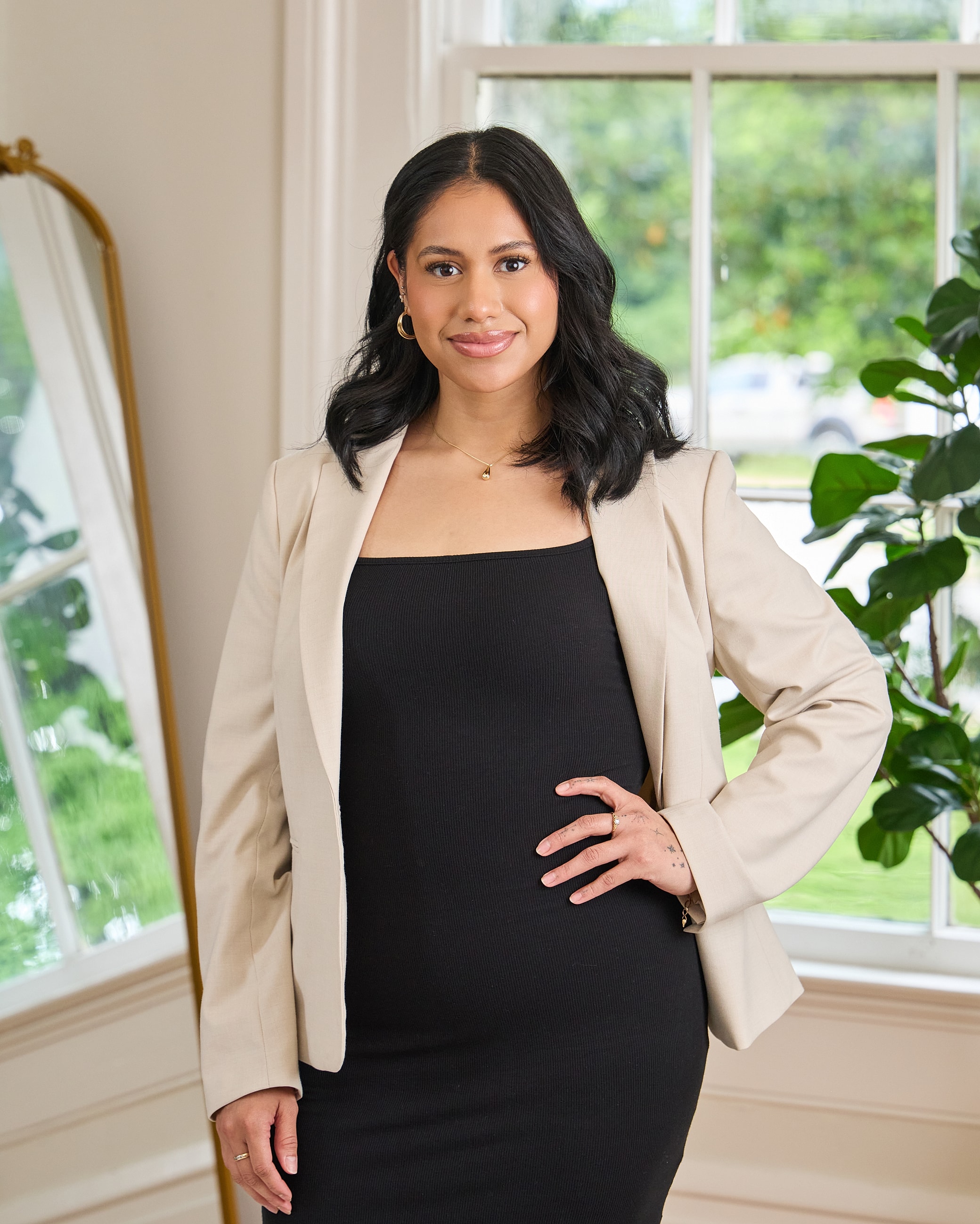 Professional woman in a stylish outfit indoors.