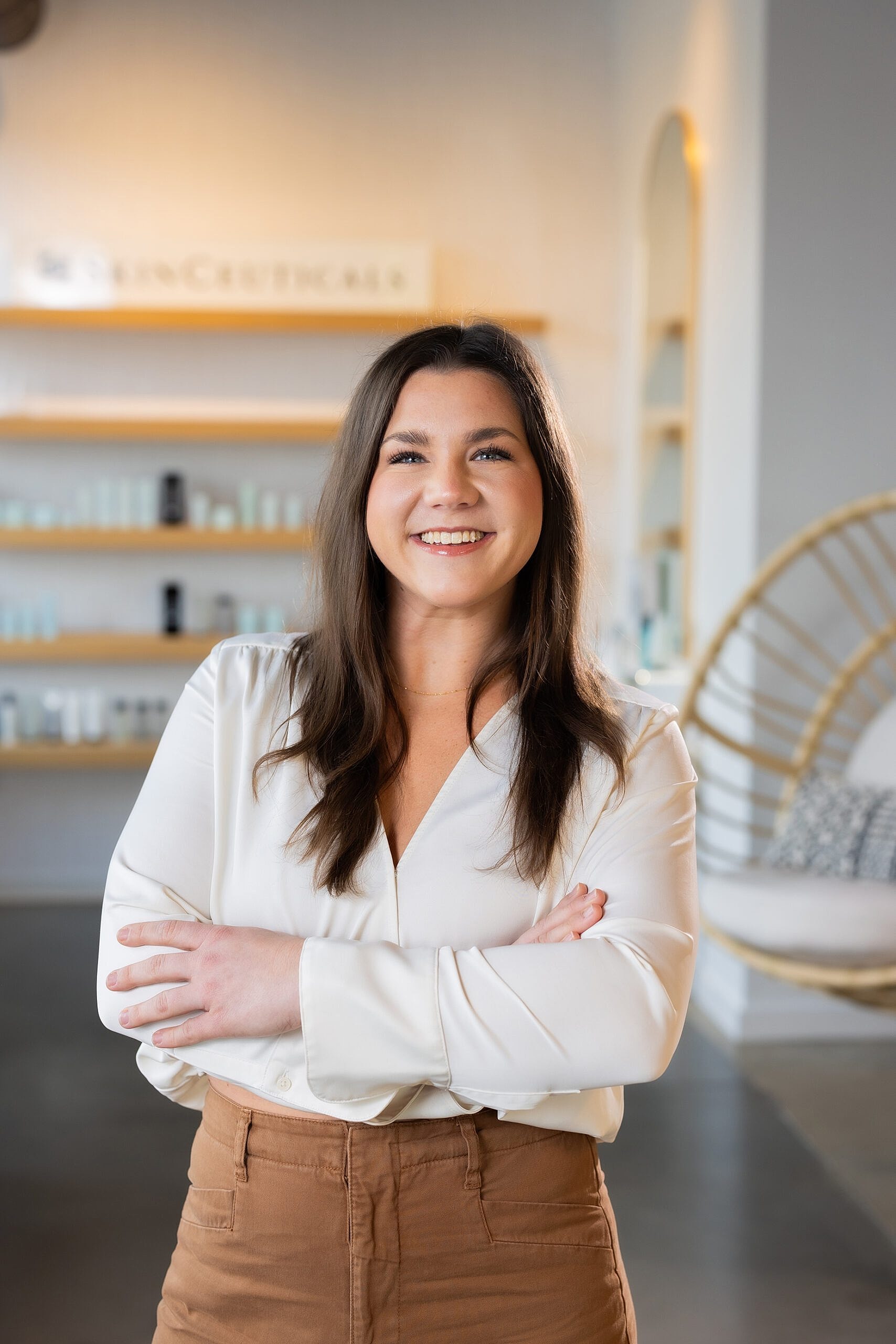 Smiling woman in a bright, modern setting.