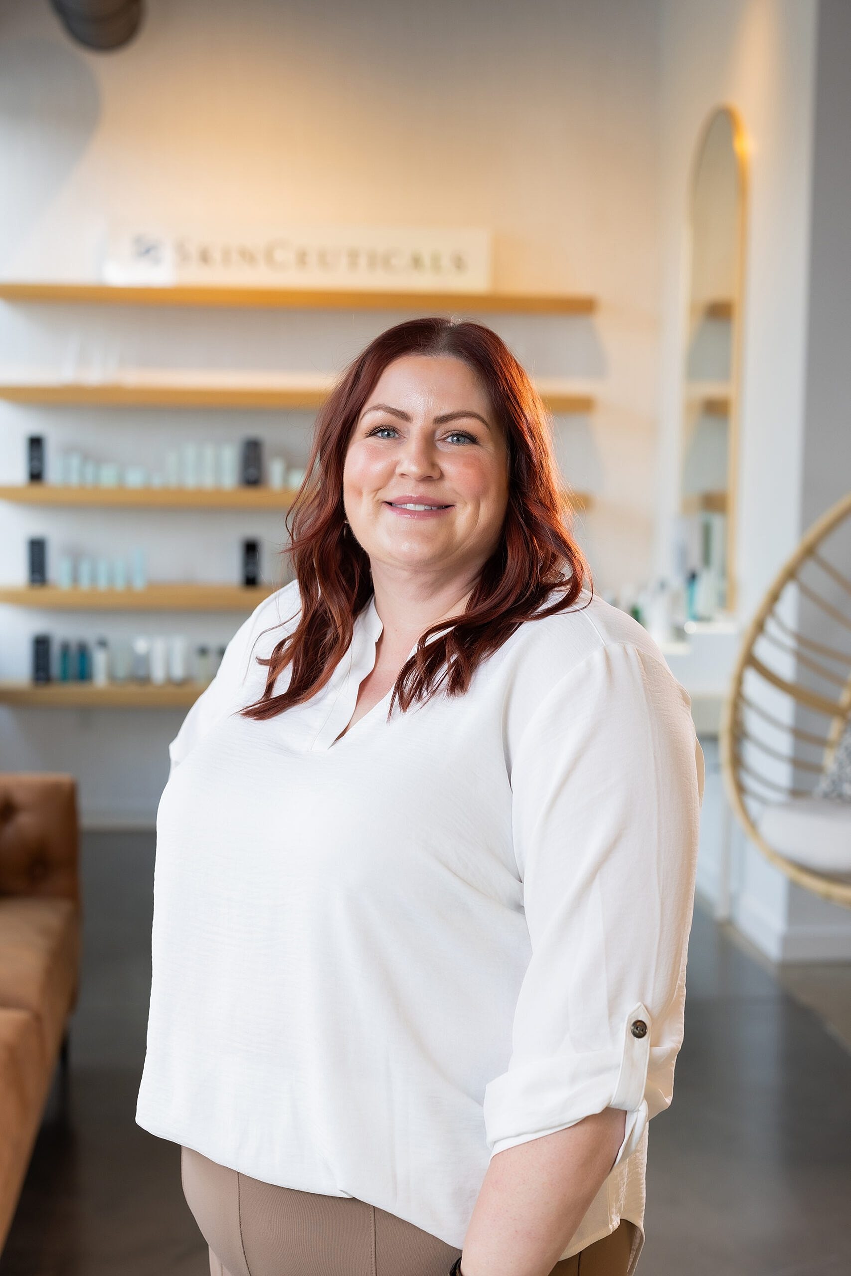 Smiling woman in skincare store setting.
