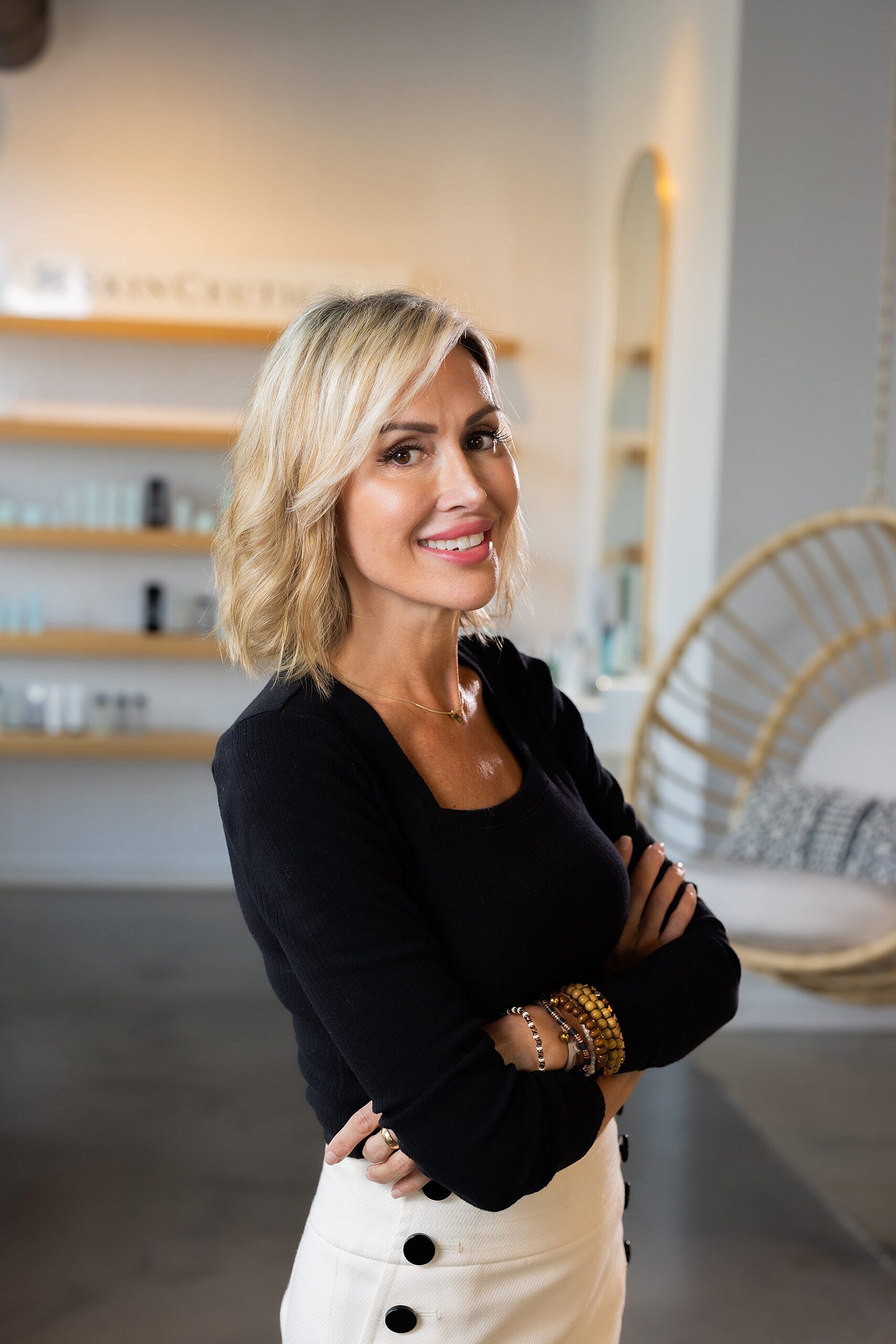 Smiling woman in a stylish, modern setting.